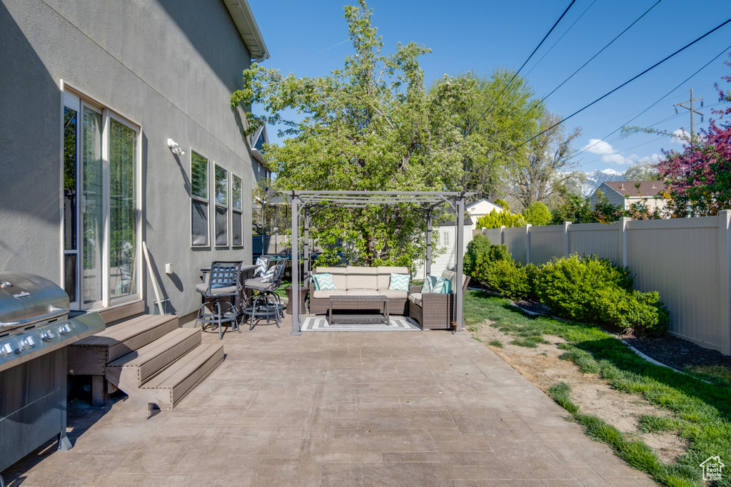 View of terrace featuring a grill, a pergola, and an outdoor hangout area