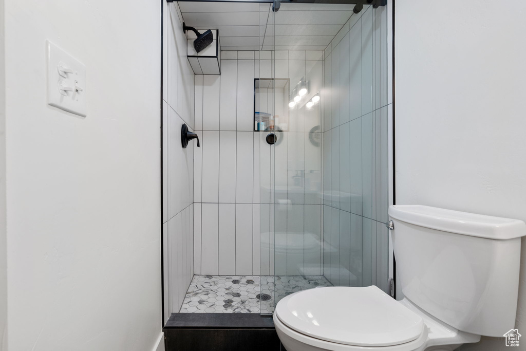 Bathroom with tiled shower and toilet