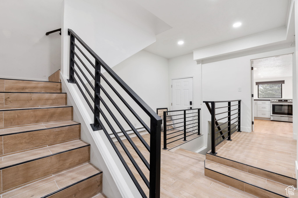 Stairs with light wood-type flooring