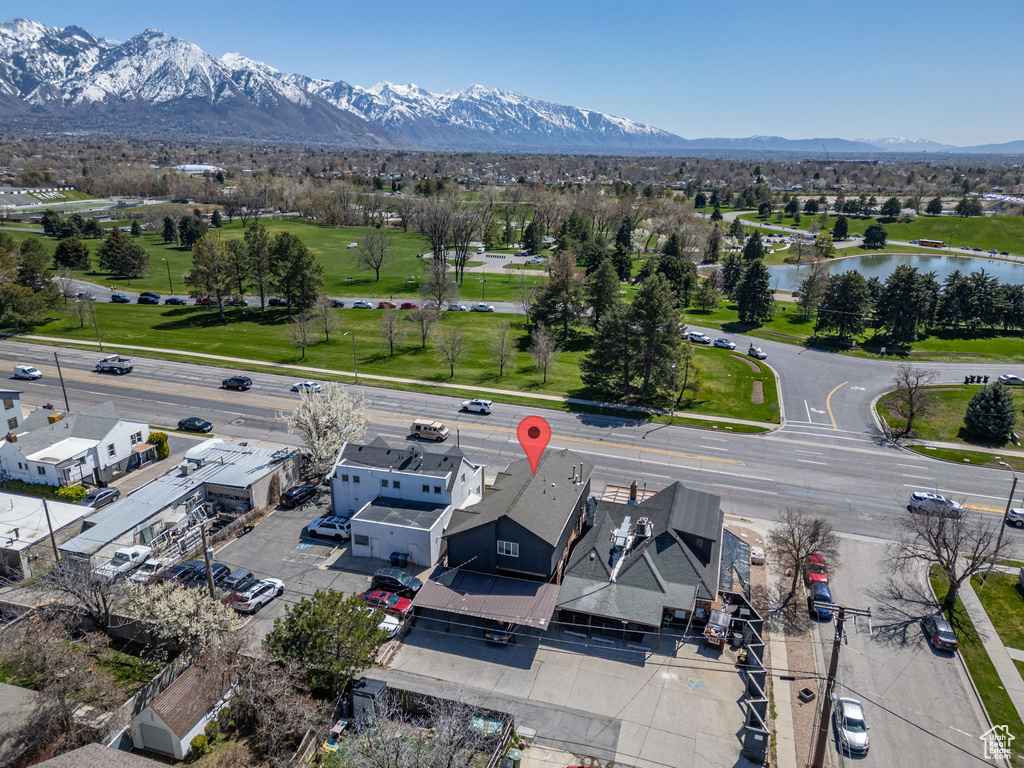 Birds eye view of property with a water and mountain view