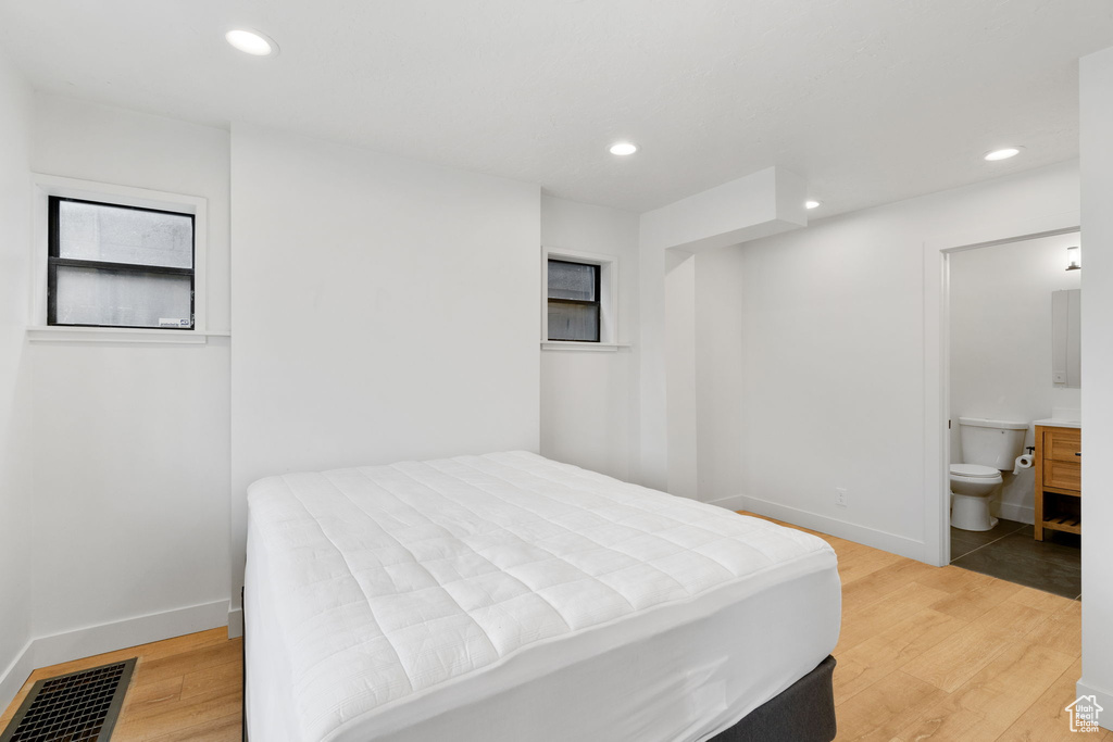 Bedroom featuring ensuite bath and light tile floors