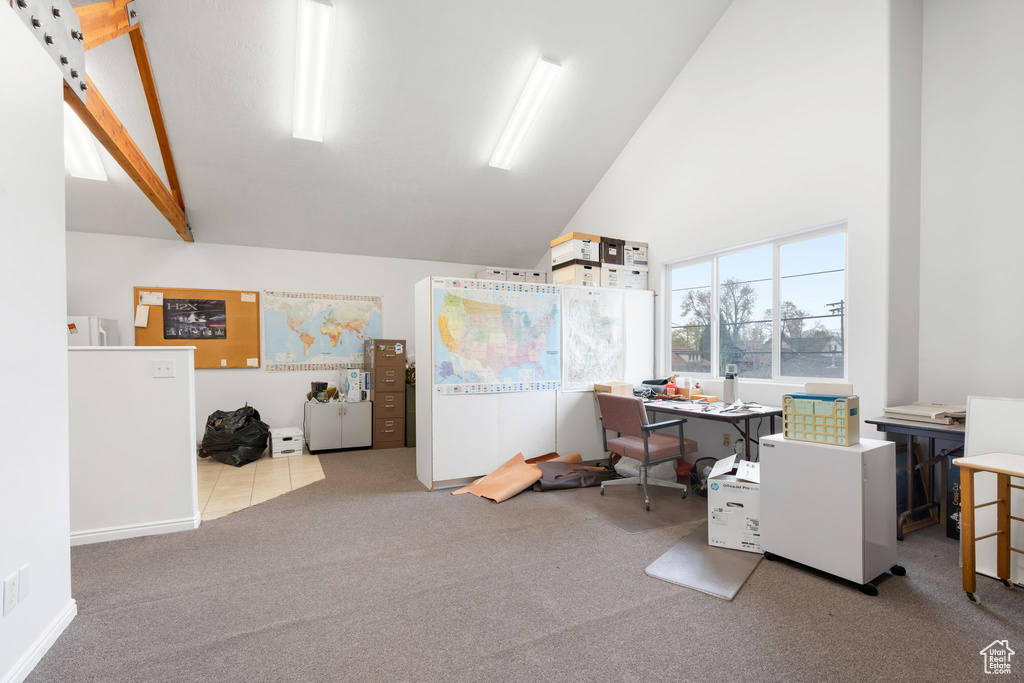 Office with high vaulted ceiling, beam ceiling, and carpet