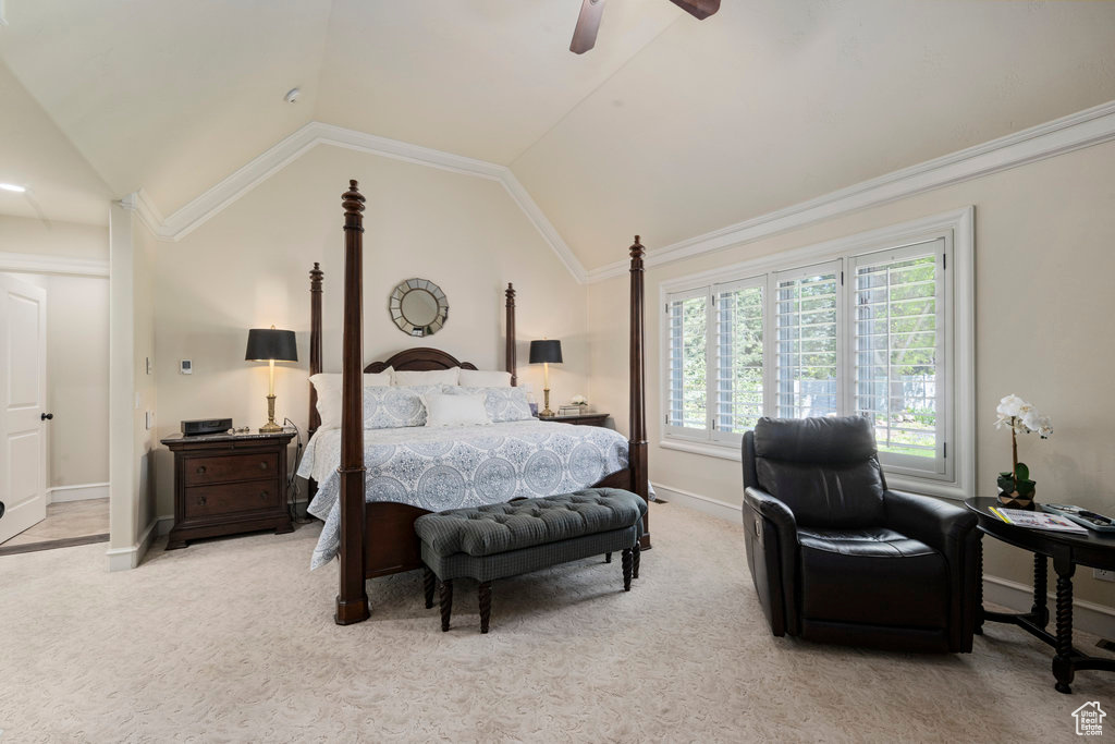 Bedroom featuring lofted ceiling, ceiling fan, carpet flooring, and crown molding