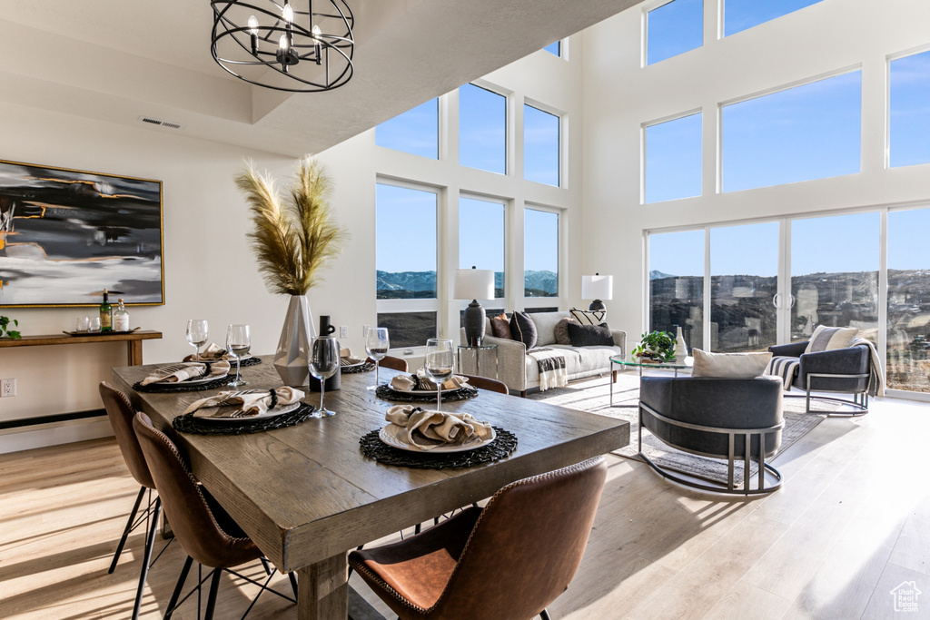 Dining area featuring a mountain view, a healthy amount of sunlight, and light hardwood / wood-style flooring