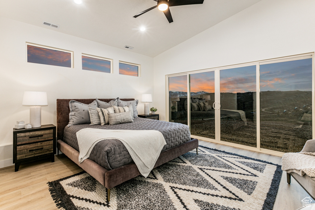 Bedroom featuring high vaulted ceiling, light hardwood / wood-style flooring, ceiling fan, and access to exterior