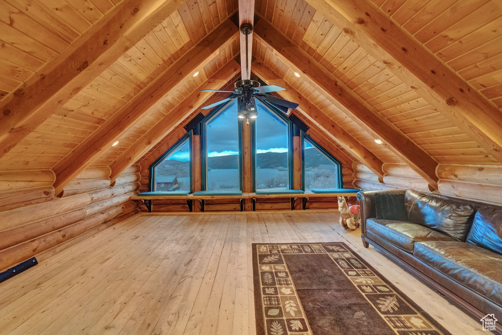 Additional living space featuring wood ceiling, log walls, and vaulted ceiling with beams
