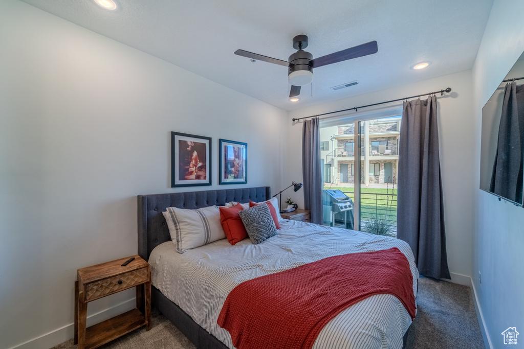 Bedroom featuring dark colored carpet, ceiling fan, and access to exterior