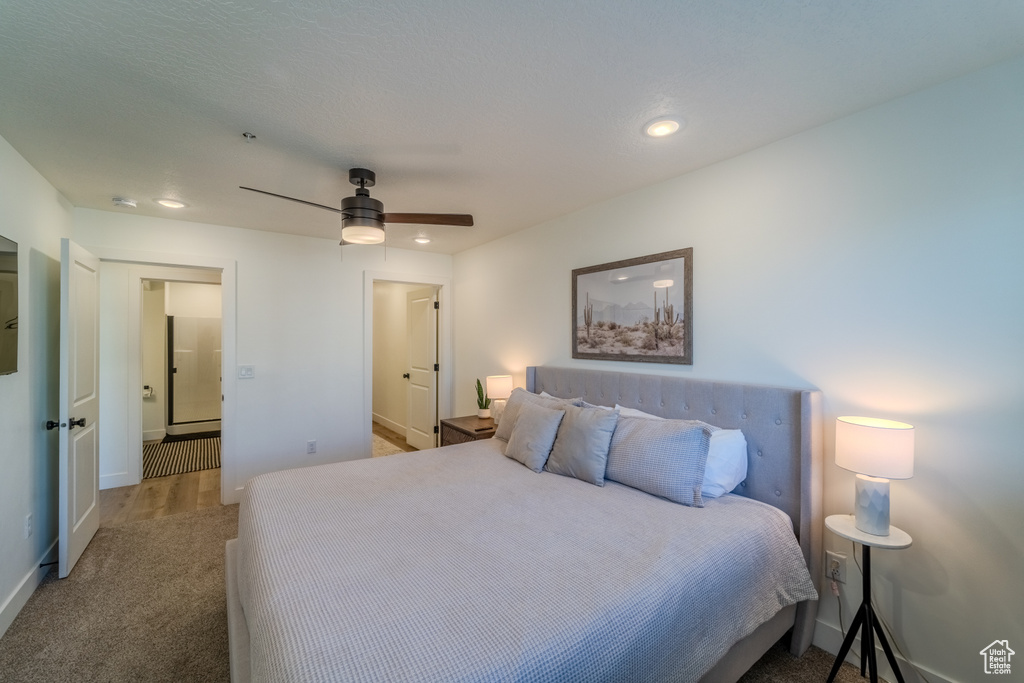 Carpeted bedroom featuring ceiling fan