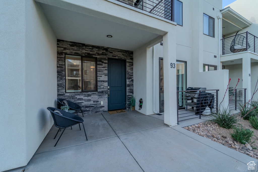 View of patio / terrace with a grill and a balcony