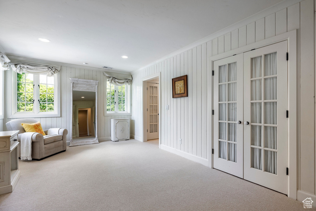 Unfurnished room featuring french doors, light carpet, and ornamental molding