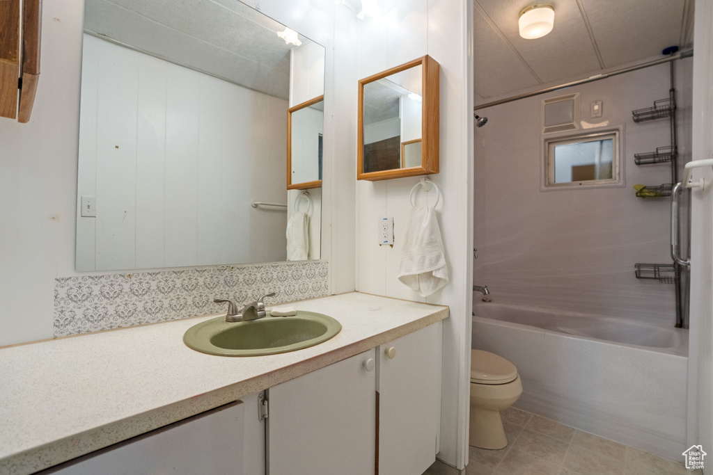 Full bathroom featuring tile floors, shower / bathing tub combination, toilet, and large vanity
