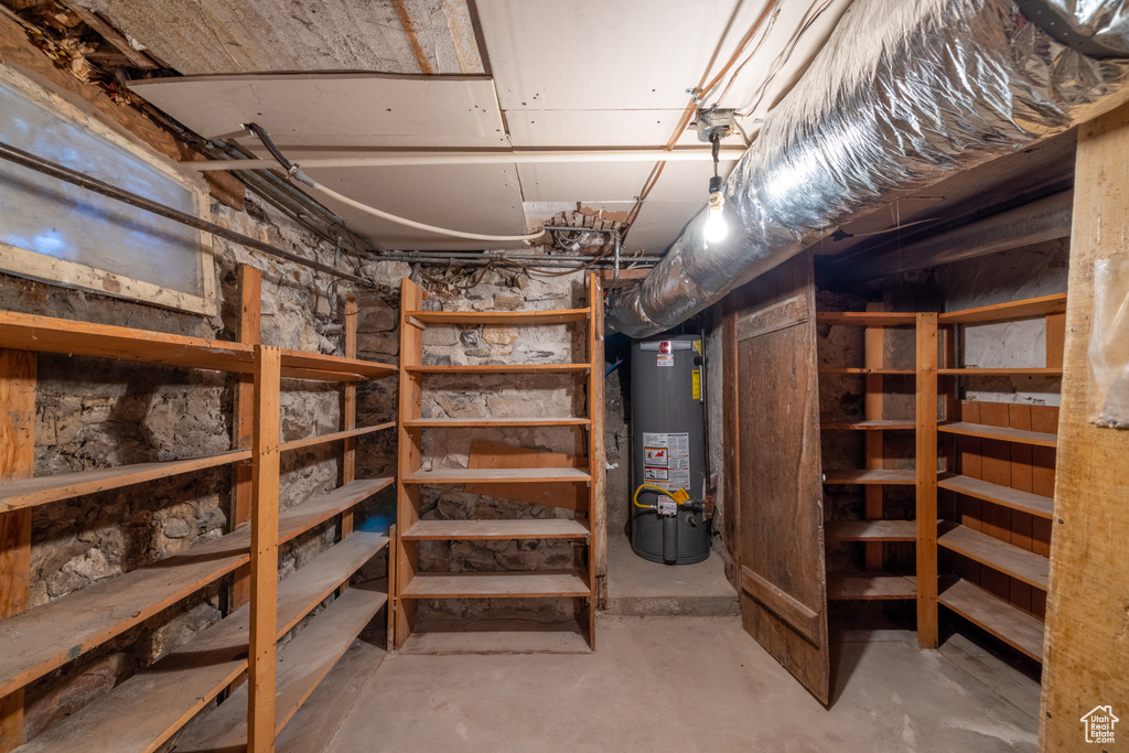 Storage room featuring water heater