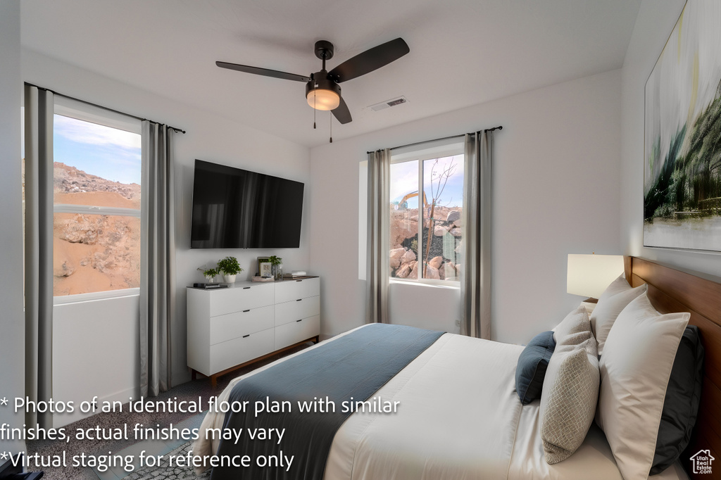 Bedroom featuring ceiling fan and multiple windows