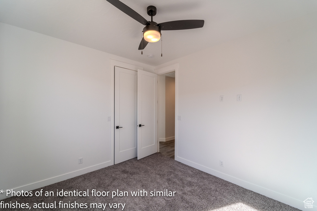 Unfurnished bedroom with carpet flooring and ceiling fan