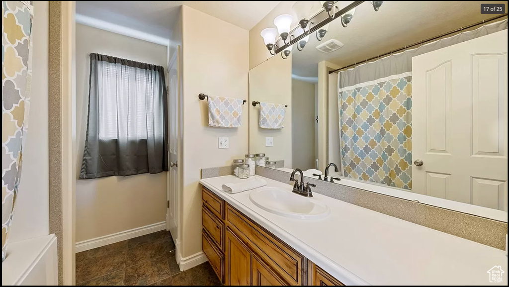 Bathroom featuring tile floors and large vanity