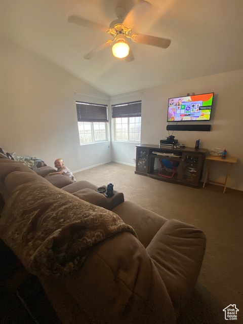 Living room featuring carpet, ceiling fan, and lofted ceiling