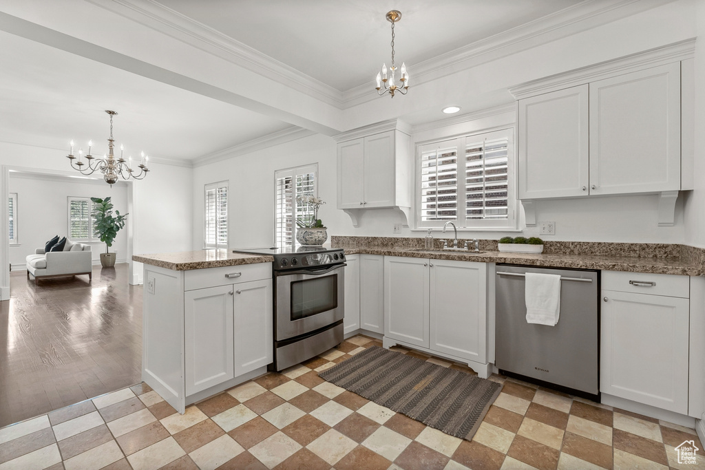 Kitchen featuring white cabinets, kitchen peninsula, stainless steel appliances, light tile floors, and sink