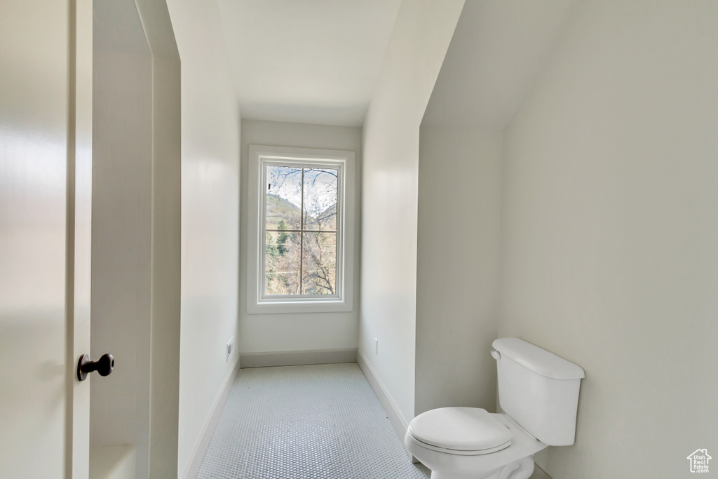 Bathroom with toilet and tile flooring
