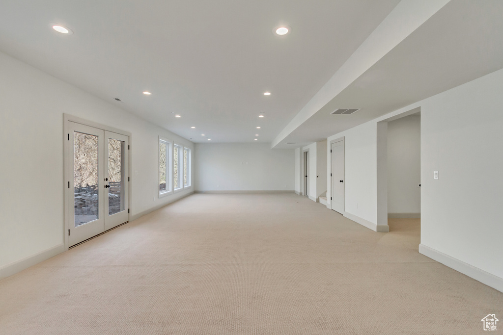 Interior space featuring light colored carpet and french doors