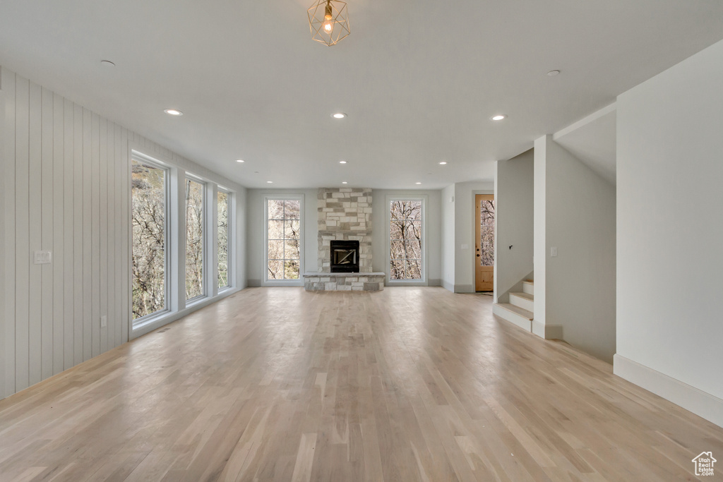 Unfurnished living room with light hardwood / wood-style floors and a fireplace
