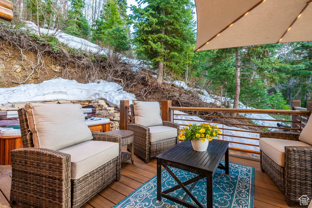 Snow covered deck with an outdoor living space
