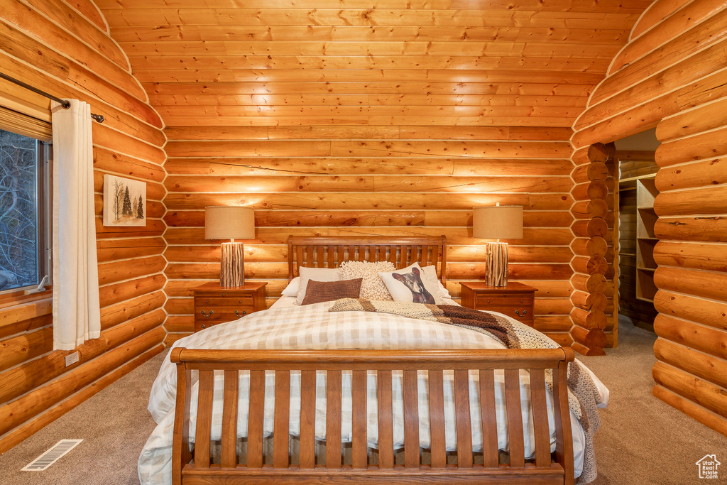 Unfurnished bedroom featuring wood ceiling, rustic walls, carpet, and vaulted ceiling
