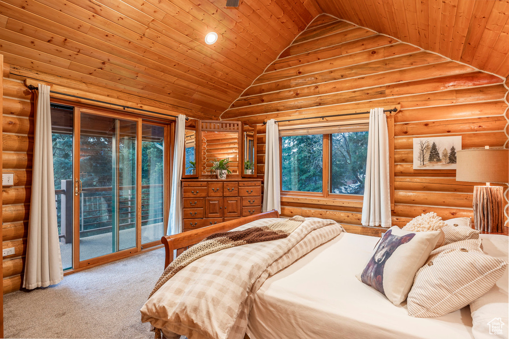 Bedroom featuring log walls, lofted ceiling, access to outside, and wood ceiling