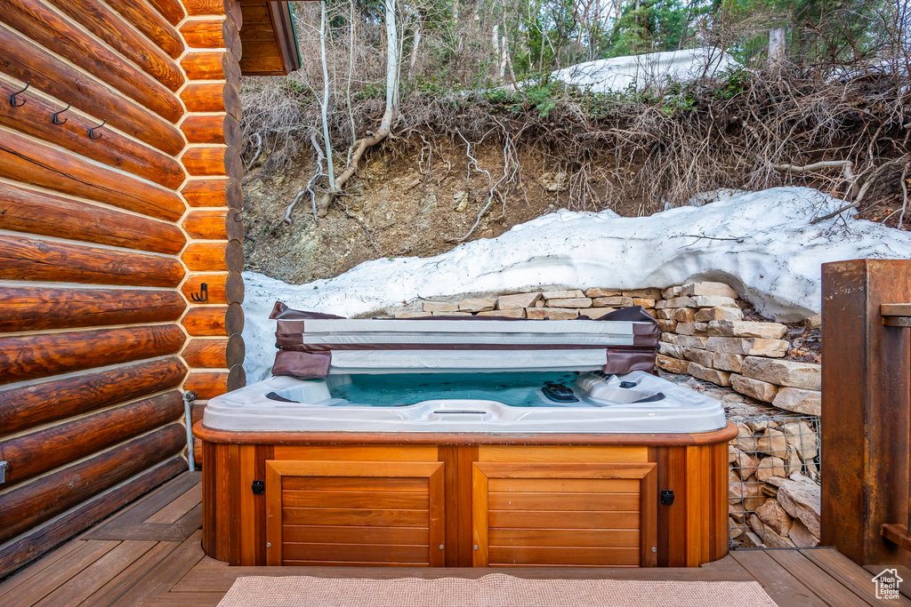 Wooden deck featuring a hot tub