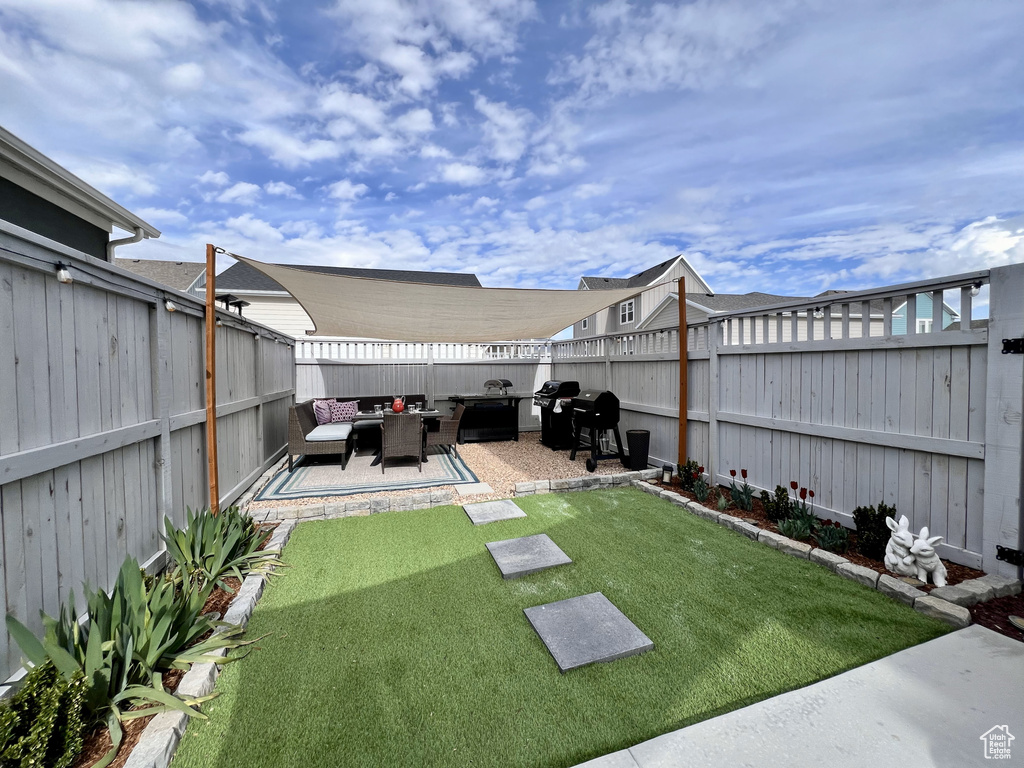 View of yard featuring a patio area and an outdoor hangout area