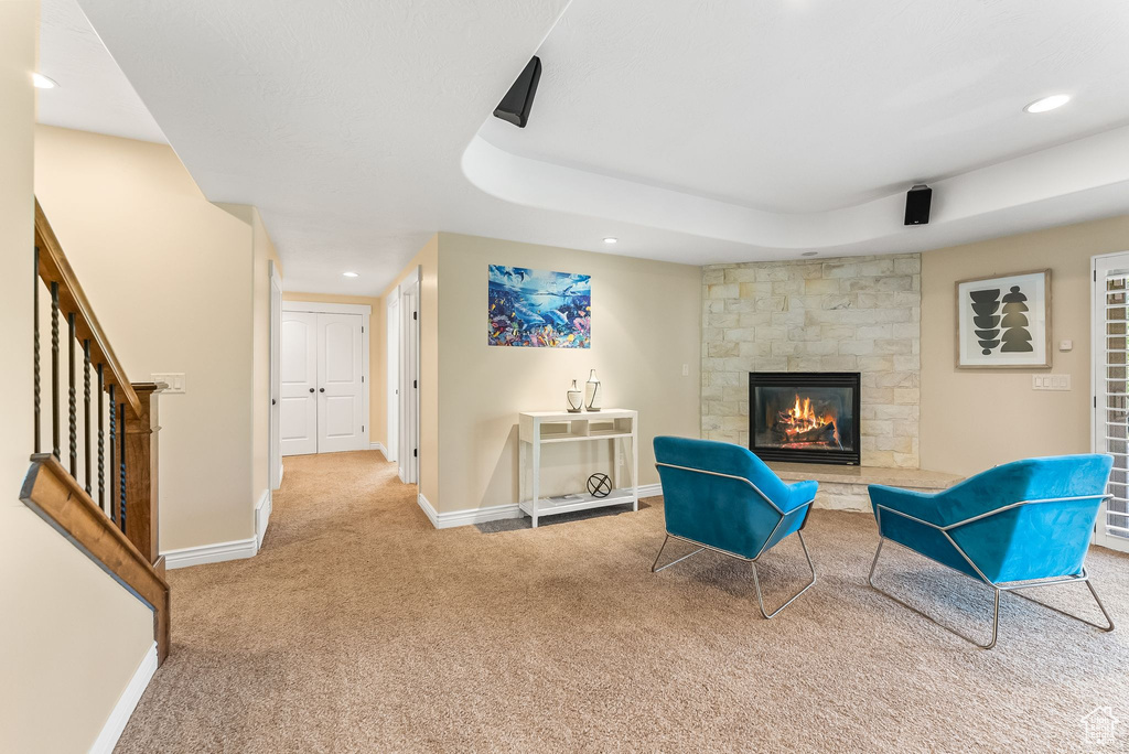 Living area with carpet floors and a fireplace