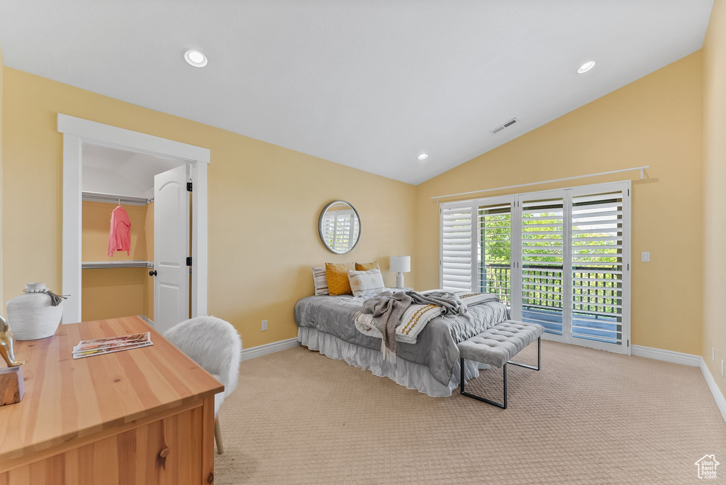 Carpeted bedroom featuring lofted ceiling and access to exterior