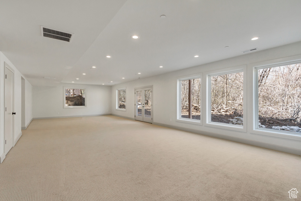 Interior space with a healthy amount of sunlight and light colored carpet