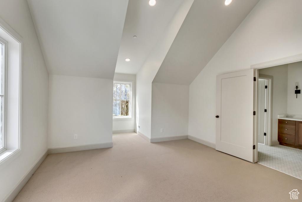 Bonus room featuring light carpet and lofted ceiling