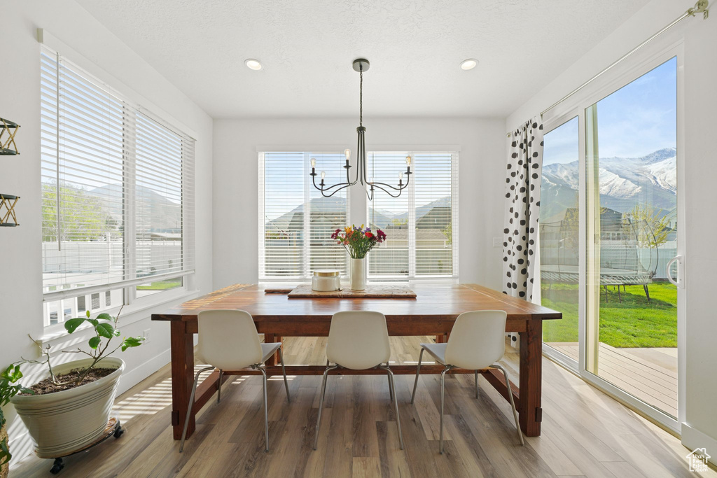 Interior space featuring a mountain view, a healthy amount of sunlight, and a chandelier