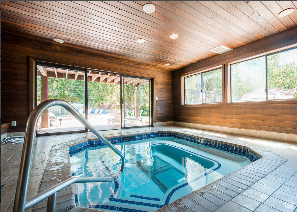 View of swimming pool with an indoor hot tub