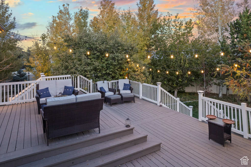 Deck at dusk featuring an outdoor living space