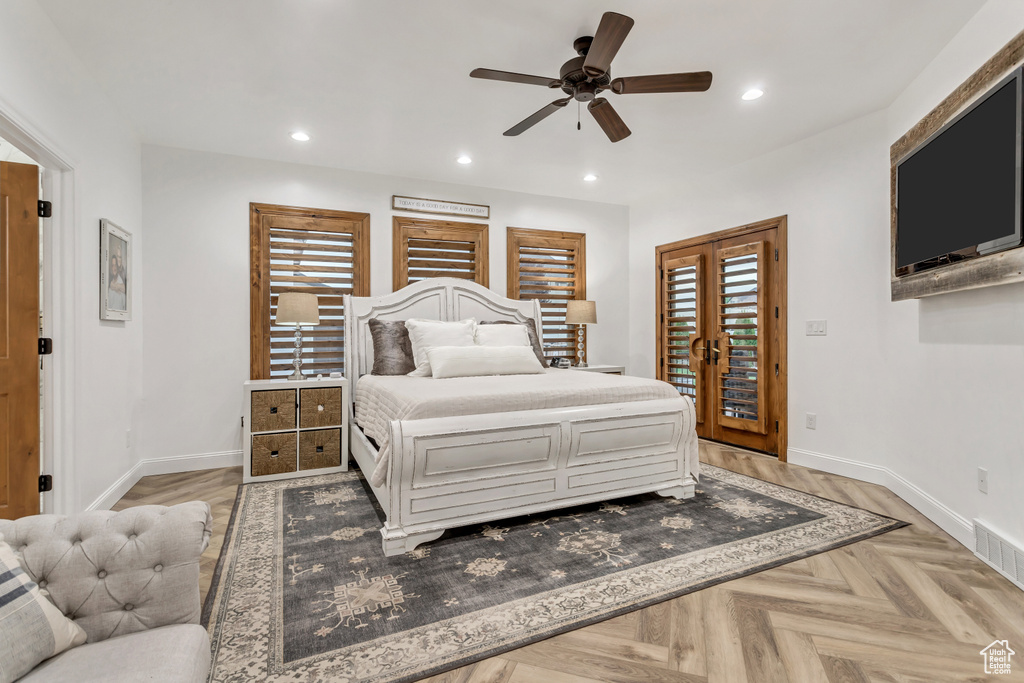 Bedroom with parquet flooring, french doors, ceiling fan, and access to outside