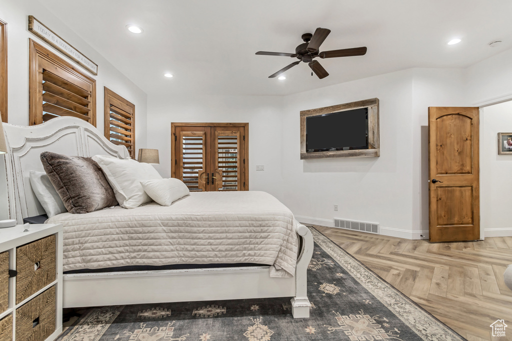Bedroom with french doors, ceiling fan, and parquet floors