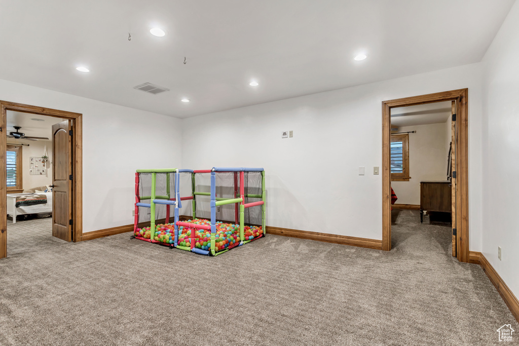 Recreation room featuring carpet flooring and ceiling fan