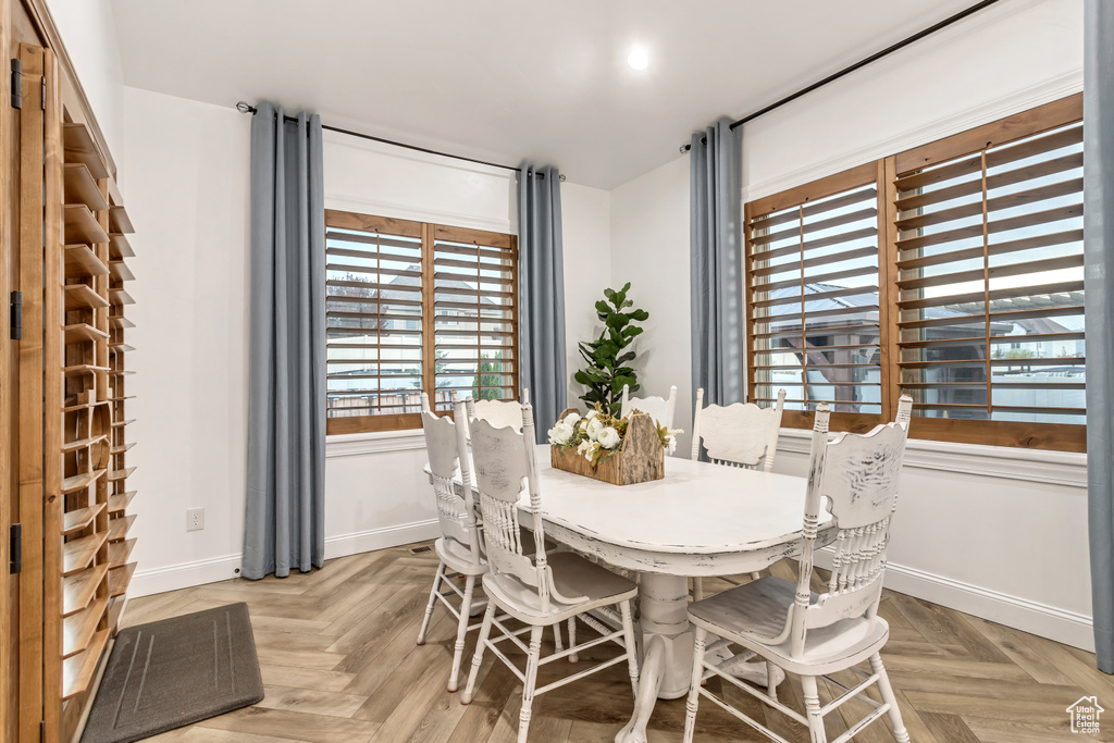 Dining space featuring light parquet floors