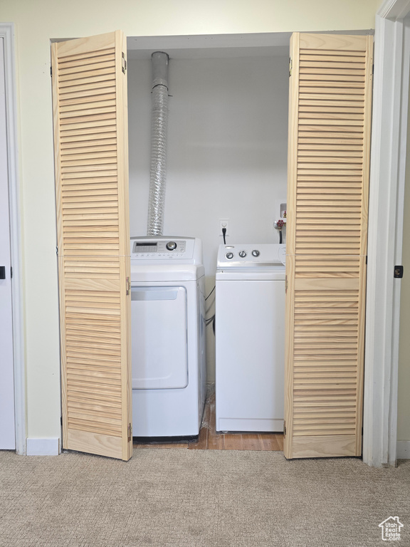 Washroom with washing machine and dryer and carpet