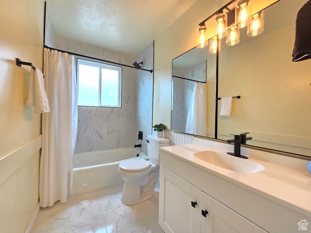 Full bathroom with shower / bathtub combination with curtain, toilet, oversized vanity, and tile flooring