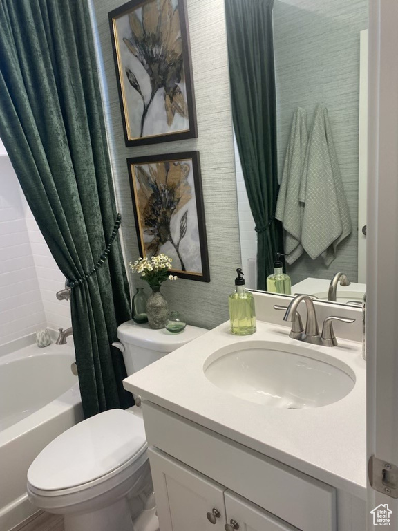 Full bathroom with shower / tub combo with curtain, vanity, and toilet