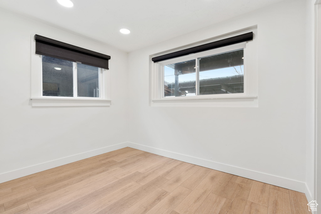 Empty room with light hardwood / wood-style floors