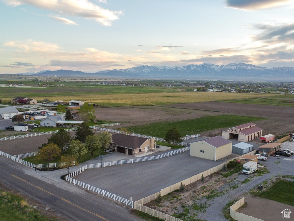 Aerial view at dusk featuring a rural view and a mountain view