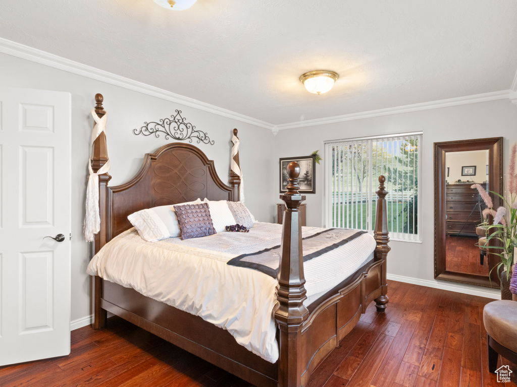Bedroom featuring hardwood / wood-style floors and crown molding