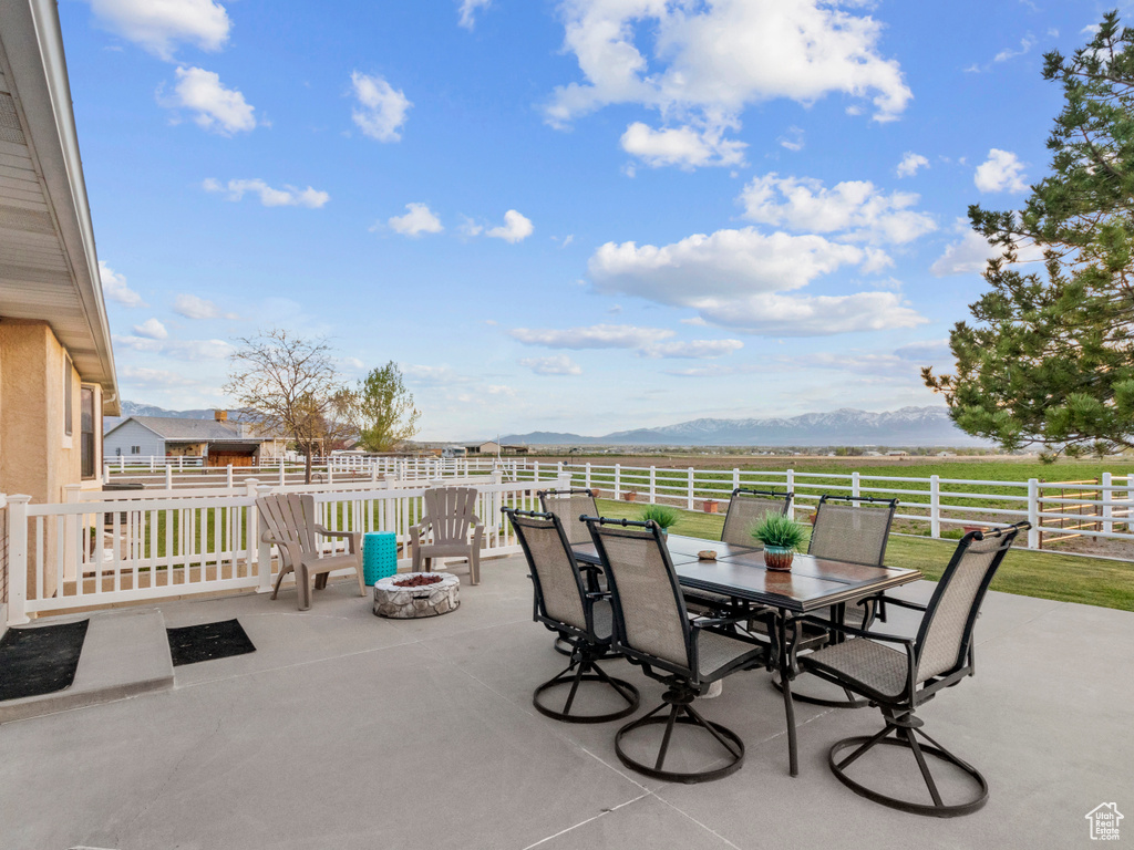 View of patio / terrace featuring a mountain view and a fire pit