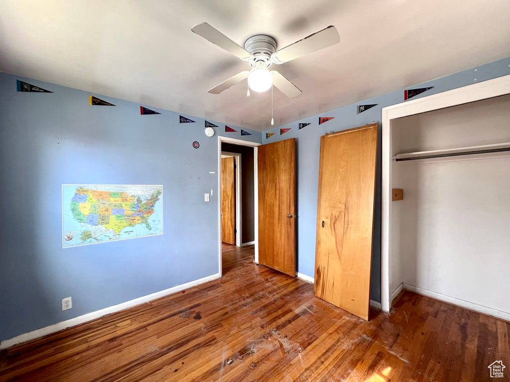 Unfurnished bedroom featuring ceiling fan and hardwood / wood-style flooring