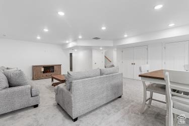 Living room with recessed lighting and light colored carpet