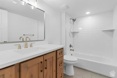 Full bathroom with bathtub / shower combination, vanity, toilet, and tile patterned floors